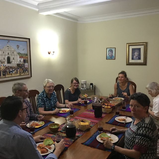 Gruppe von Freunden genießt gemeinsam eine Mahlzeit am Esstisch.